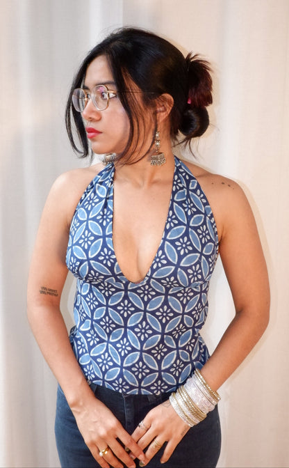 Backless GEET halter neck top in pure cotton with a playful botanic clash print.